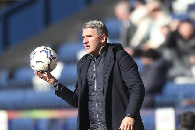 Preston North End manager Ryan Lowe holds the ball during the game against Queens Park Rangers at Deepdale