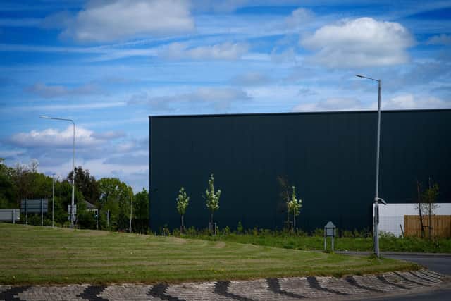 A new landscaping plan will see hundreds of shrubs and trees planted in the vicinity of the warehouses - but concerns remain over drainage issues