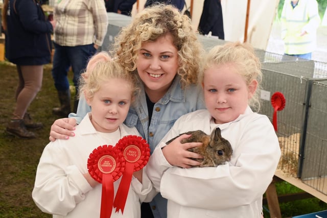 Sheryl Tubbs with Ella, six, left, and Sophia, nine, right, and their award-winning rabbit.