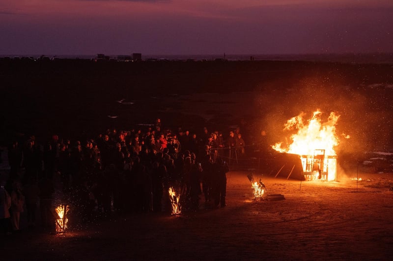 Crowds look on as the boat and braziers burn at the More Music memorial event on Morecambe beach to mark 20 years since the cockling tragedy.