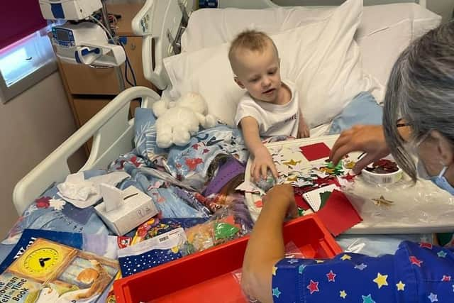 Freya Duckworth, pictured in hospital during her treatment, with play specialist Anya.