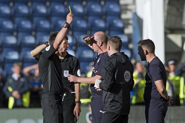 Wigan manager Paul Cook is booked