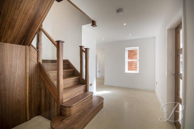 One of the tantalising features of the house is this stunning, solid walnut staircase, fitted with a glass balustrade.