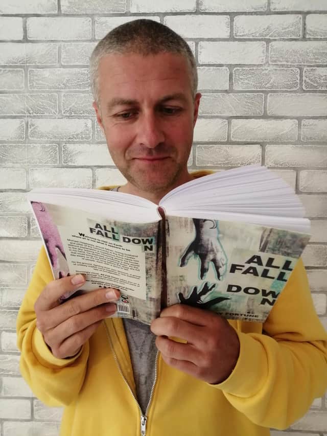 Jay Fortune with his newly published book All Fall Down