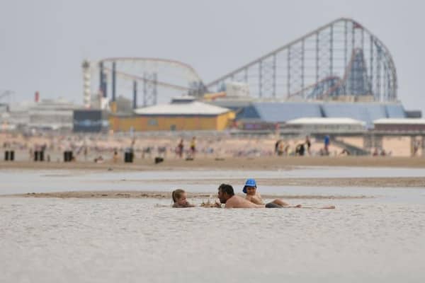 People enjoy the warm weather on the Blackpool Beach (Photo by Anthony Devlin/Getty Images)