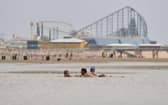 People enjoy the warm weather on the Blackpool Beach (Photo by Anthony Devlin/Getty Images)