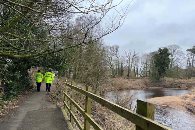 Officers patrolling the riverside path