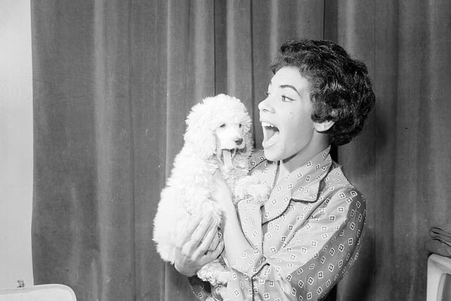 Singer Shirley Bassey backstage with her poodle at the Empire theatre in September 1958.