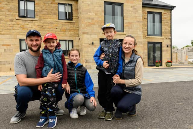 Pictured from left Misha, Davyd, Solomia, Pasha and Lena Petrochenko outside their new apartment       Photo: Kelvin Stuttard