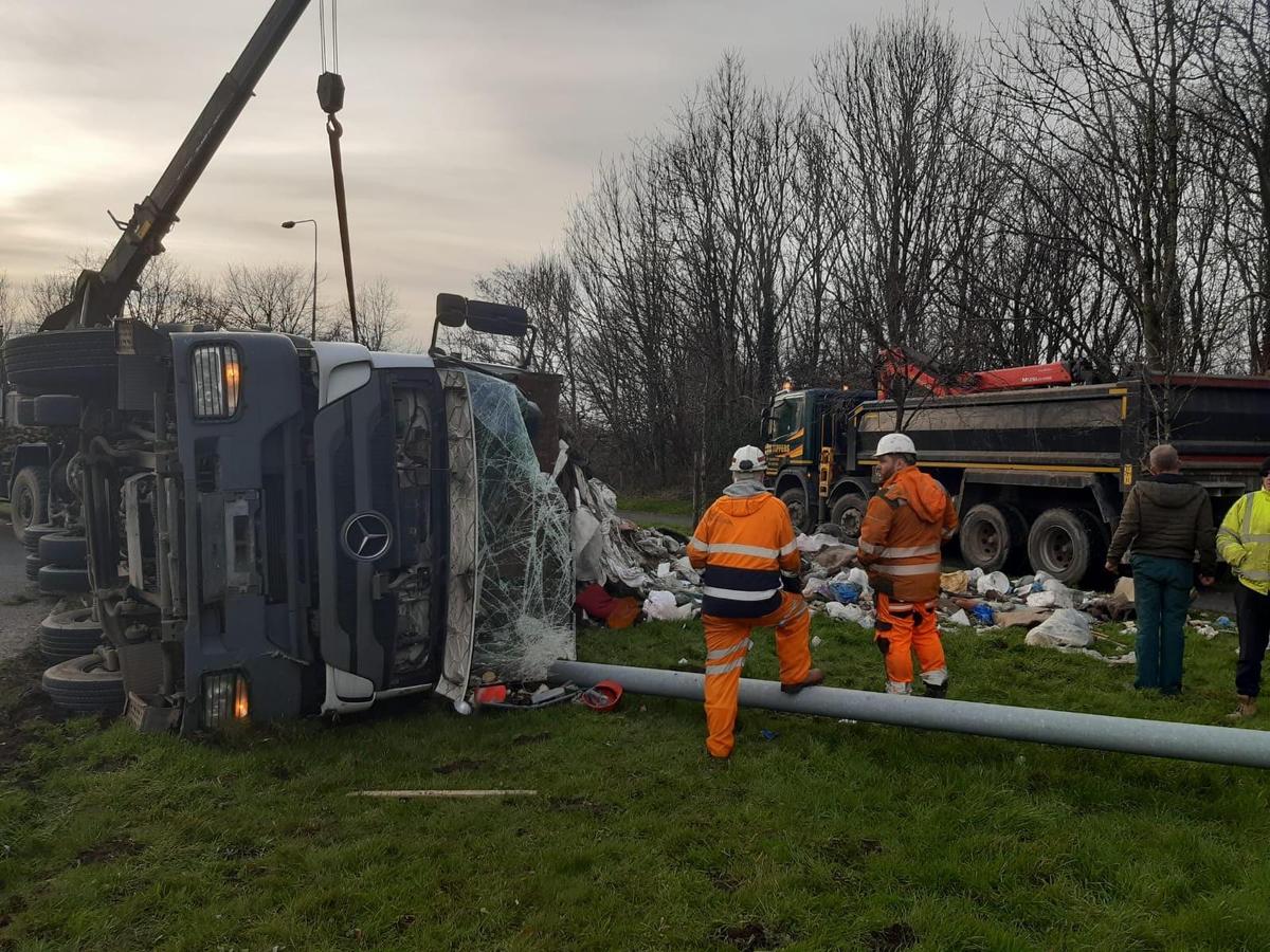 Heavy congestion after lorry overturns and sheds its load on roundabout
