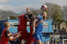 Andy Teague goes up for an aerial duel surrounded by brig defenders (photo:Phil Dawson)