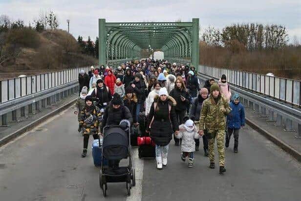 Ukrainian refugees pictured on the border with Poland shortly after the start of the war - 82 of those who fled their homes are now in Preston (image:  Daniel Leal/AFP via Getty Images)