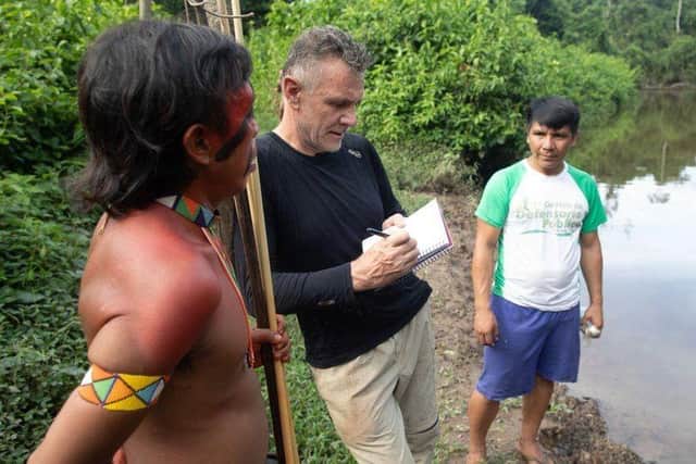 Dom Phillips talking to two indigenous men in Roraima State, Brazil in 2019. Photo: Getty Images
