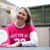 Donna Russell holds the Race for Life sign proudly to show her personal motivation for supporting the charity’s much-loved events