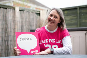 Donna Russell holds the Race for Life sign proudly to show her personal motivation for supporting the charity’s much-loved events