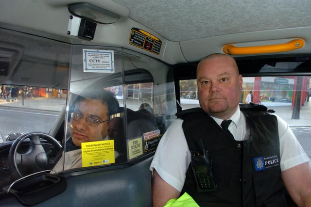 CCTV cameras inside Sheffield taxis ... South Yorkshire police Sgt Mark Wortley and Hafeas Rehman, secretary Sheffield Taxi trade association in one of the taxis fitted with cameras in February  2007