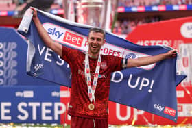 Paul Huntington of Carlisle United celebrates the team's victory and promotion to League One