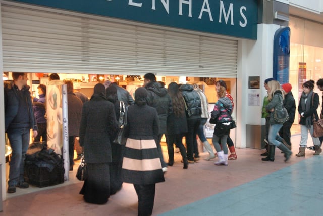 Bargain hunters wait for the shutters to go up at Fishergate Shopping Centre's Debenhams store as it opens for Boxing Day sales