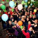 Up, up and away... Children from St Mary's and St Benedict's RC Primary School, Bamber Bridge, celebrate the beginning of National Library Week with a balloon launch at the Bamber Bridge Library, Preston