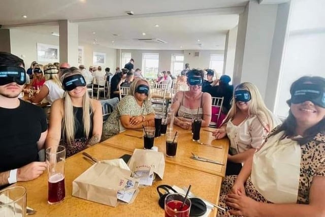 Blindfolded diners enjoy a drink as they wait for their food to arrive at the Dine In The Dark experience in Cleveleys.