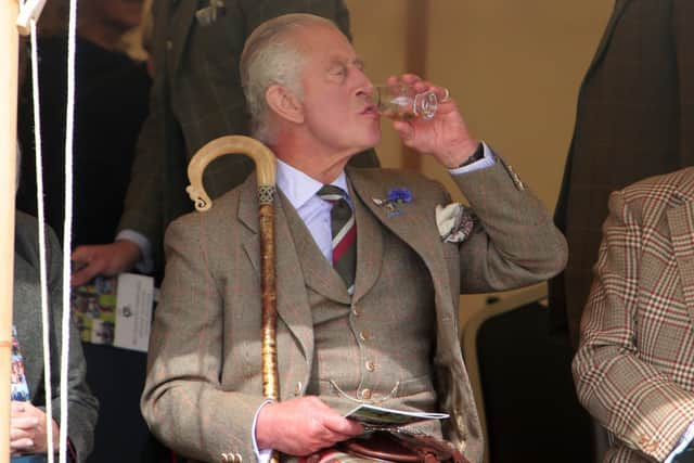 King Charles III enjoys a dram during the Mey Highland Games at the John O'Groats Showground in Caithness. Photo by Robert MacDonald/PA Wire