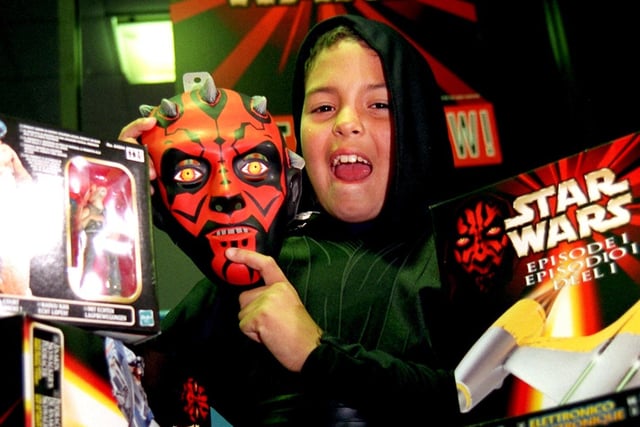 Andrew Yongching, nine, with some of his new toys after waiting for hours at Toys R Us, Preston, for the sale of Star Wars merchandise back in 1999