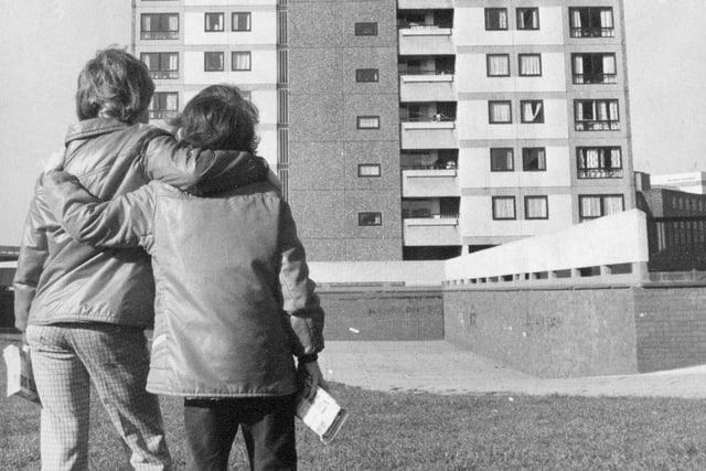 Two children take a look at the tower blocks at Avenham