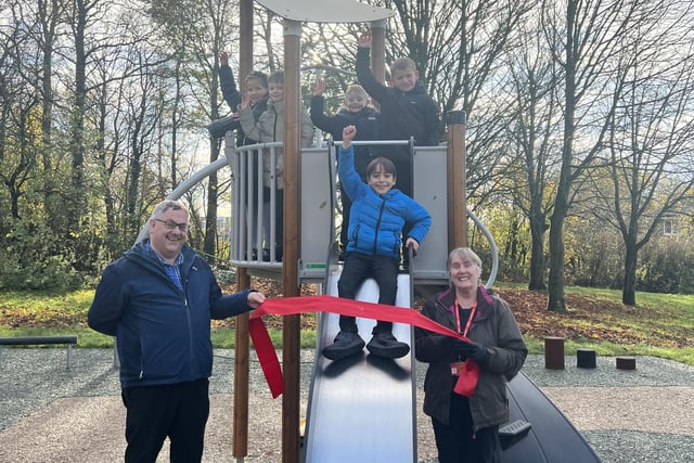 Councillor Adrian Lowe, Councillor Jean Sherwood and children from Buckshaw Primary School officially open the newly refurbed Foxcote Play Area