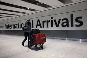LONDON, ENGLAND - NOVEMBER 28: A man wears a face covering at Heathrow Terminal 5 on November 28, 2021 in London, England. Following the discovery of a new Covid-19 variant, whose mutations  suggest greater transmissibility than previous virus strains, the United Kingdom imposed new restrictions on arriving travelers. From 04:00 today, people arriving from South Africa, Botswana, Lesostho, Eswatini, Zimbabwe and Namibi, Malawi, Mozambique, Zambia, and Angola will face mandatory hotel quarantine. From Tuesday, all international travelers must isolate until they return a negative PCR test, which must be taken by Day 2. (Photo by Hollie Adams/Getty Images)