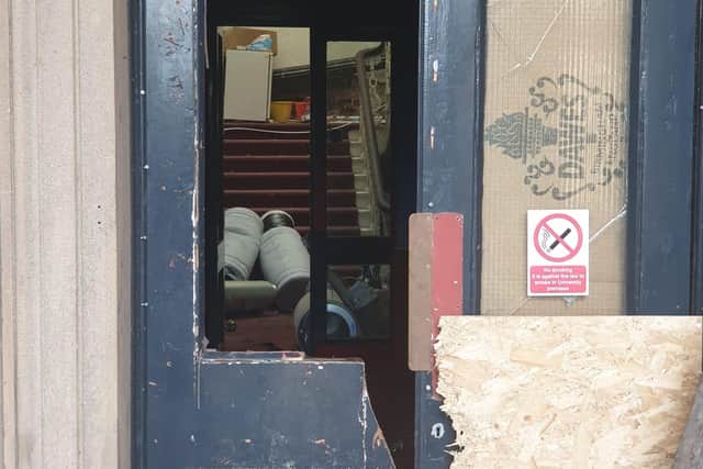 The smashed-in door of the Harris Institute after intruders entered the building on Wednesday (image: George Bailey)