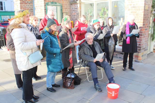 Fundraisers serenaded the shoppers in town.
