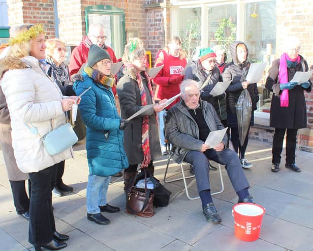 Fundraisers serenaded the shoppers in town.