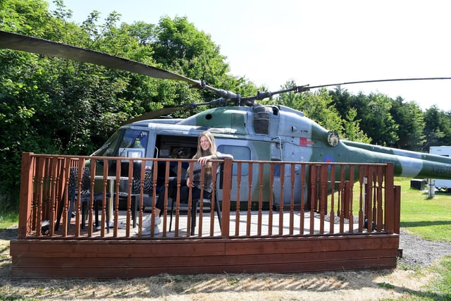 Katie relaxes on the decking outside the Lynx helicopter