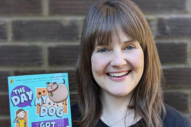 Jen Carney holding her latest book, The Day My Dog Got Famous