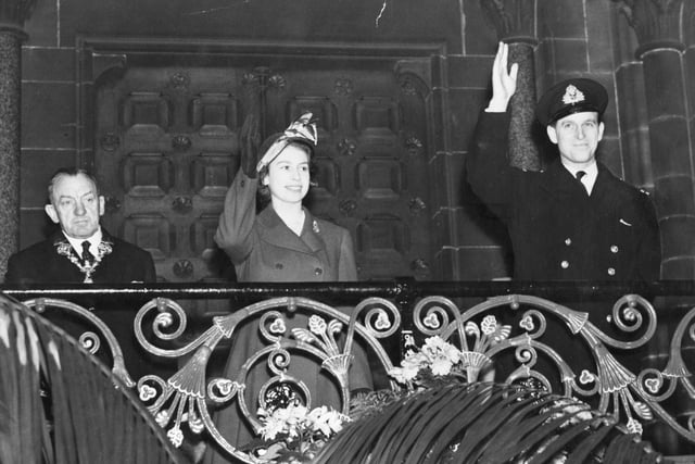 Waving from a balcony during the same visit in 1949 - Princess Elizabeth is pictured here with Alderman R Ainsworth (left) - the Mayor of Preston at the time