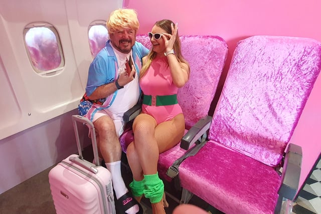 Ken and Barbie get set for a holiday - in the mock airplane seat at Selfie Town
