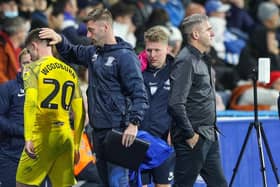 Preston North End first team coach Paul Gallagher alongside Ryan Lowe and midfielder Ben Woodburn on the touchline