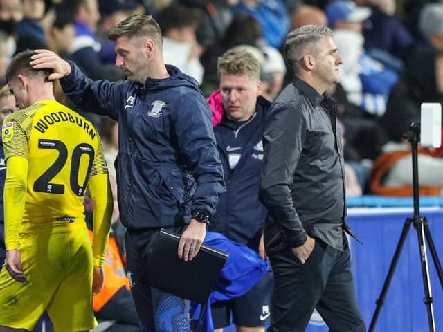Preston North End first team coach Paul Gallagher alongside Ryan Lowe and midfielder Ben Woodburn on the touchline