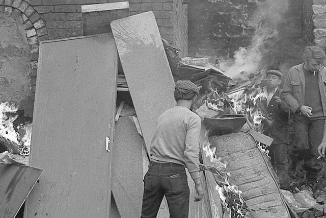 Debris being piled up and set on fire at the scene of a chimney being taken down in Lancaster in the mid 1970s. Picture courtesy of Keith Taylor.