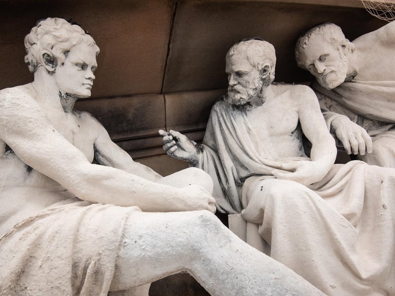 Figures from Ancient Greece in deep conversation above the streets of Preston