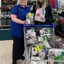 Emma Bailey, community champion at Tesco Rawtenstall (left), with the Christmas hampers