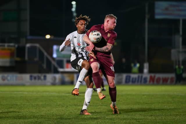 Will Tomlinson in the thick of the action against Hereford (photo; Stefan Willoughby)