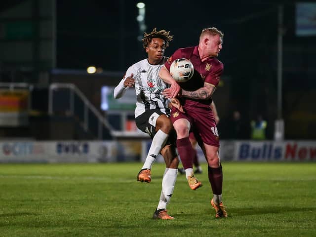 Will Tomlinson in the thick of the action against Hereford (photo; Stefan Willoughby)