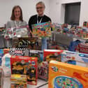 Burnley Together co-ordinator Nicola Larnach (left) with Ella Roberts, a customer service advisor for Calico, with some of the many toys and gifts donated by the public to the 2023 Christmas Present Appeal