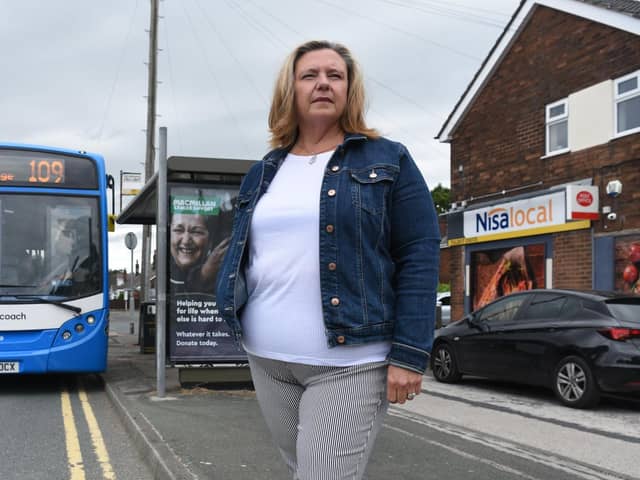 Chorley borough councillor Debra Platt at a bus stop on Balshaw Lane in Euxton, with a full-size single decker of the type that has been promised for every journey on service no.109 between Preston and Chorley from next month