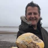 Jonathan Pearson with the waxy yellow rock he found on Morecambe beach which he hopes is potentially valuable whale vomit.