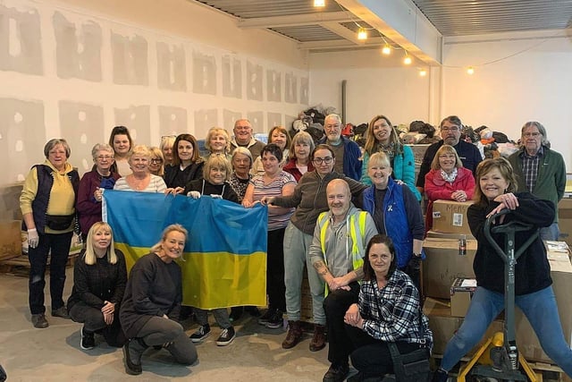 Chorley and District's group co-ordinator and volunteer Stuart Clewlow with others pictured with the flag he received from Ukraine as a thank you for helping with relief aid supplies