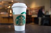 A Starbucks coffee cup (Photo by SAUL LOEB/AFP via Getty Images)