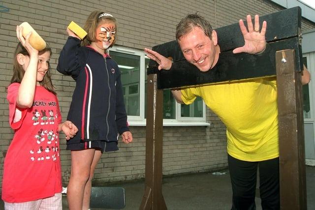 John Dalgleish, head teacher at Queens Drive Primary School, Fulwood, Preston, gets a soaking from pupils Rebecca Gregson and Jennifer Prosser at the Summer Fair
