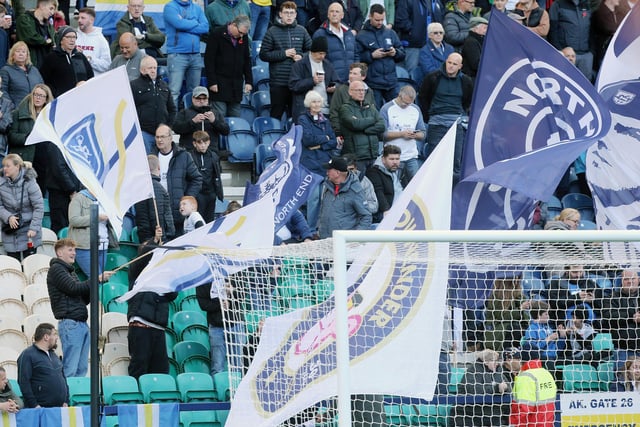 Preston North End fans wave banners and flags as they welcome their side onto the pitch ahead of kick-off